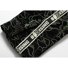 BAPE X 88RISING GLOW IN THE DARK CAMO TRACK PANTS MENS